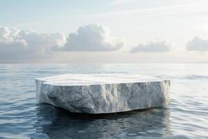 A large rock podium stage sits in the middle of the ocean photo