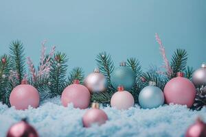 Festive Christmas ornaments nestled in snow with a cool blue background photo