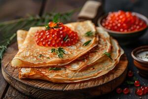 Traditional Russian crepes topped with luxurious red caviar, garnished with fresh herbs on a rustic wooden board photo