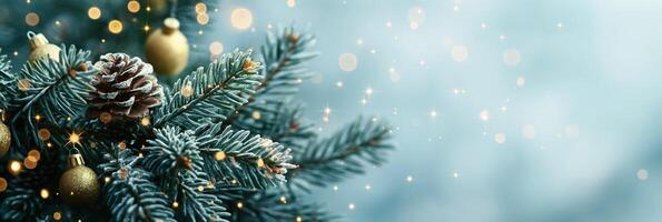 Sparkling Christmas tree branches with pine cones and golden ornaments, beautifully arranged on a frosty blue bokeh background photo