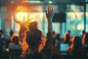 Person raising hand in audience at event photo