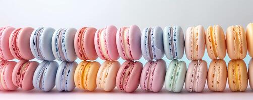 Colorful macarons in a row on gradient background photo