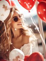 A beautiful woman with a joyful expression is surrounded by heart-shaped balloons, celebrating Valentines Day photo