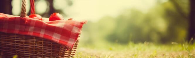 Summer picnic banner with wicker basket on lush grass photo