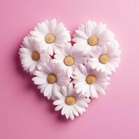 Heart-shaped arrangement of white daisies on pink backdrop photo