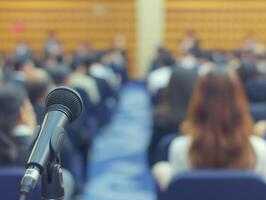 Lecture hall with attendees focused and business blurred background photo