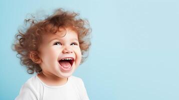 Laughing child with brown curls against blue background for ads photo