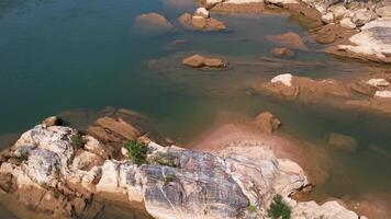 Aerial view of tranquil clear water and unique rock formations in the Annamite Range, Vietnam, showcasing the natural beauty and serene landscape of Southeast Asia video