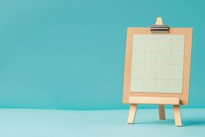 Wooden calendar on blue background for International Picnic and Panic Day. photo