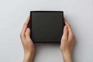 Female hands open empty black box in studio. photo