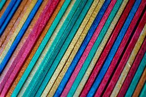 multi colored wooden craft sticks, colorful background photo