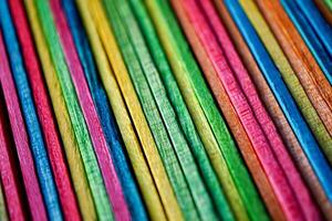 Multi colored wooden craft sticks, colorful background photo