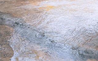 Water beneath the floor surged up through cracks of damaged concrete floor, directly above view photo