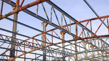 Low angle view of metal roof structure for install on top of building structure in construction site area photo