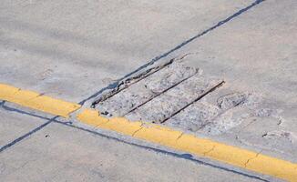 The old damaged concrete road with broken and crack texture on surface photo