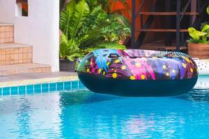 Swim ring floating on blue water in swimming pool of resort photo