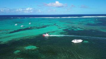 Following a boat with a drone, caribbean sea of Dominican Republic, blue waters, sunny day and white clouds, amazing tour for your holidays video