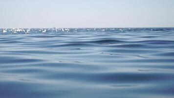 Sea water surface. Low angle view from kayak, camera flies over clear sea water. Nobody. Holiday recreation concept. Abstract nautical summer ocean nature. Slow motion. Close up. Vertical video