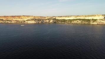 Yacht on calm sea. Luxury cruise trip. Side view of white boat on deep blue water. Aerial view of rich yacht sailing sea. Summer journey on luxury ship. video