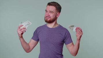 Proud arrogant rich happy man holding money cash in dollars banknotes, smiling, looking at camera video