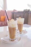 coffee is served in a tall glass glass with a straw. The concept of coffee drinks from the bar menu photo