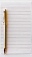 Golden Pen on Lined Notebook photo