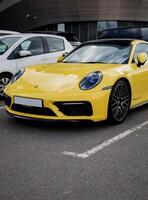 Minsk, Belarus, April 17, 2024 - Front view of car yellow Porsche 911 photo