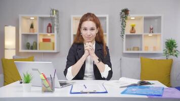 Home office worker woman makes a trust sign to the camera. video