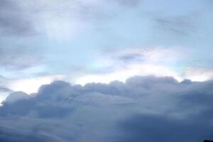 heaven cloudy sky day evening dusk time with sunlight ray from between clouds with city town background photo