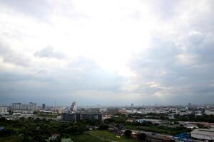 heaven cloudy sky day evening dusk time with sunlight ray from between clouds with city town background photo