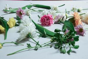 many type of bunch of flowers and leaf with spread distributed in a smooth horizontal surface photo