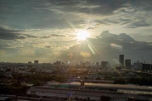 heaven cloudy sky day evening dusk time with sunlight ray from between clouds with city town background photo