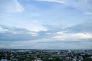 heaven cloudy sky day evening dusk time with sunlight ray from between clouds with city town background photo