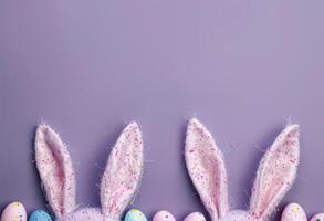 Top view illustration of easter bunny ears colorful vivid eggs and sprinkles on blue background photo