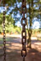 swing steel chain suspended in playground photo