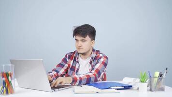 Man looking at laptop making positive gesture. video