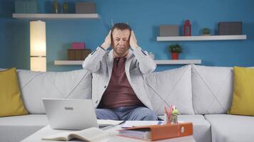 Home office worker man looks at camera with happy and smiling face. video