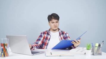 The man looking at the documents is thoughtful. video