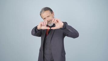 Businessman making heart at camera. video