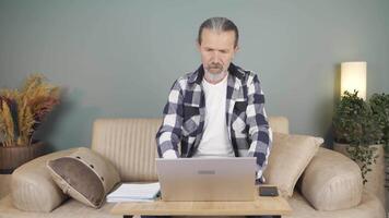 Man closing laptop with angry expression. video