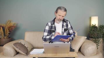 The man examining the files approves the files with his head. video