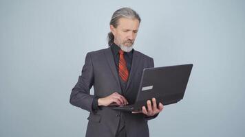 Businessman looking at laptop with excitement. video