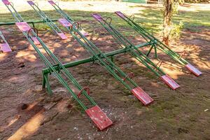 green and red metal seesaw photo