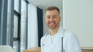 Portrait of a private practice male doctor in his medical office video