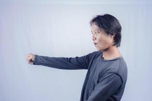 handsome asian man is excited with full force shouting and review, on isolated white background for copy space. photo