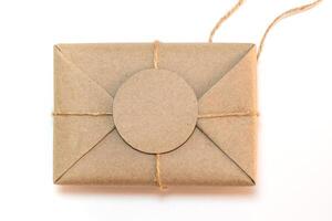 Gift box wrapped in kraft paper and rustic hemp as natural rustic style photo