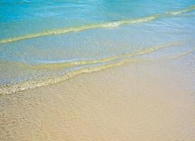 Light reflection on the surface of movement sea on sand beach photo