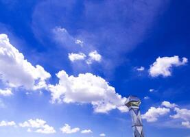 Shiny steel smokestack and cloud in sky photo