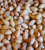 Fresh Organic Almonds with hard shell Top View Background - Dry Fruit- Nuts photo