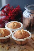 Cupcakes or muffins are on vintage wooden texture. photo